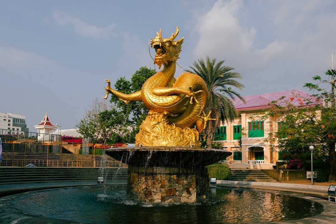 A fountain with a gold statue on top of it