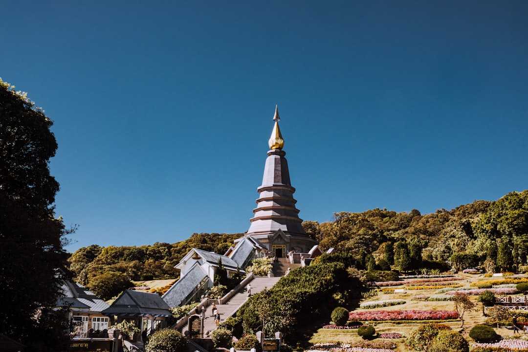 A temple stands tall under the clear, blue sky.