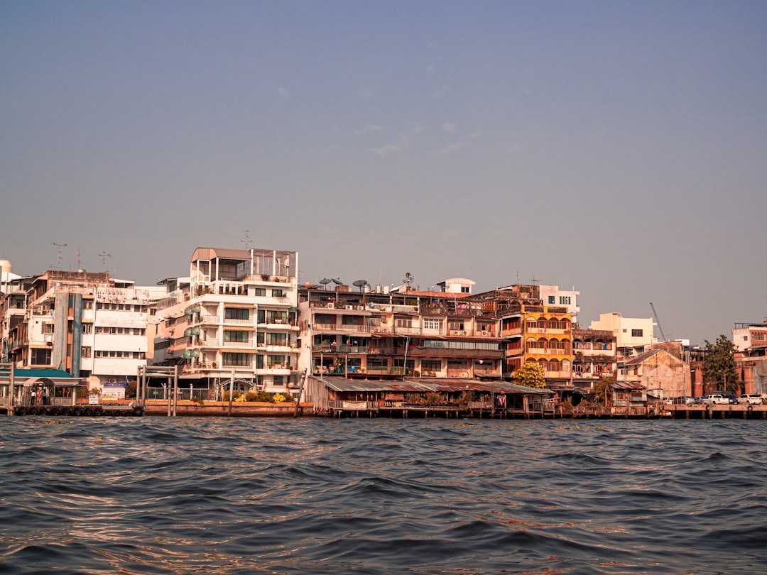 city buildings near body of water during daytime
